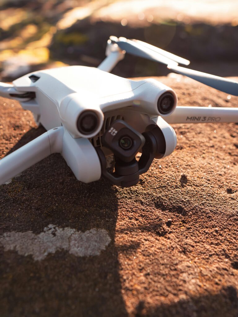 img-01-free-img Detailed shot of a drone resting on a rocky surface in natural light.